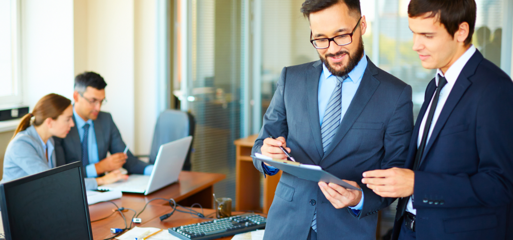 Two salesforce Consultant in blazer standing and talking in office